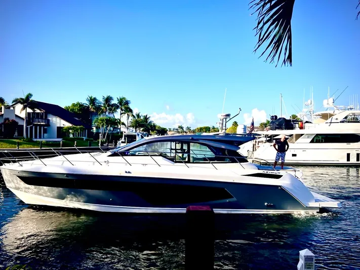 Bellisima Yacht Photos Pics 2019 Azimut Atlantis 51 yacht docked in a sunny marina setting.
