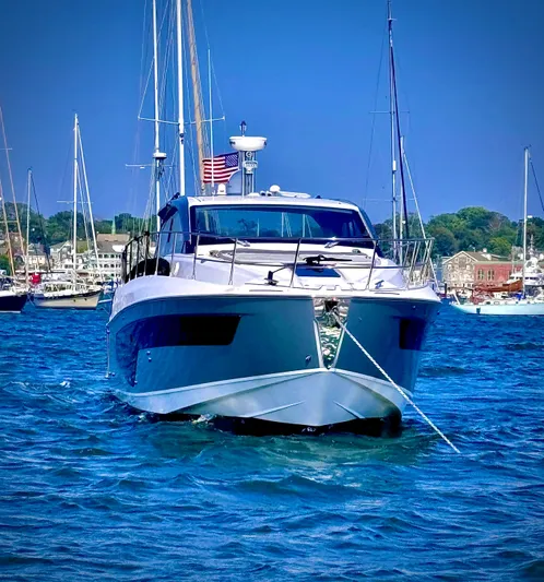 Bellisima Yacht Photos Pics 2019 Azimut Atlantis 51 yacht on blue water, with marina background.