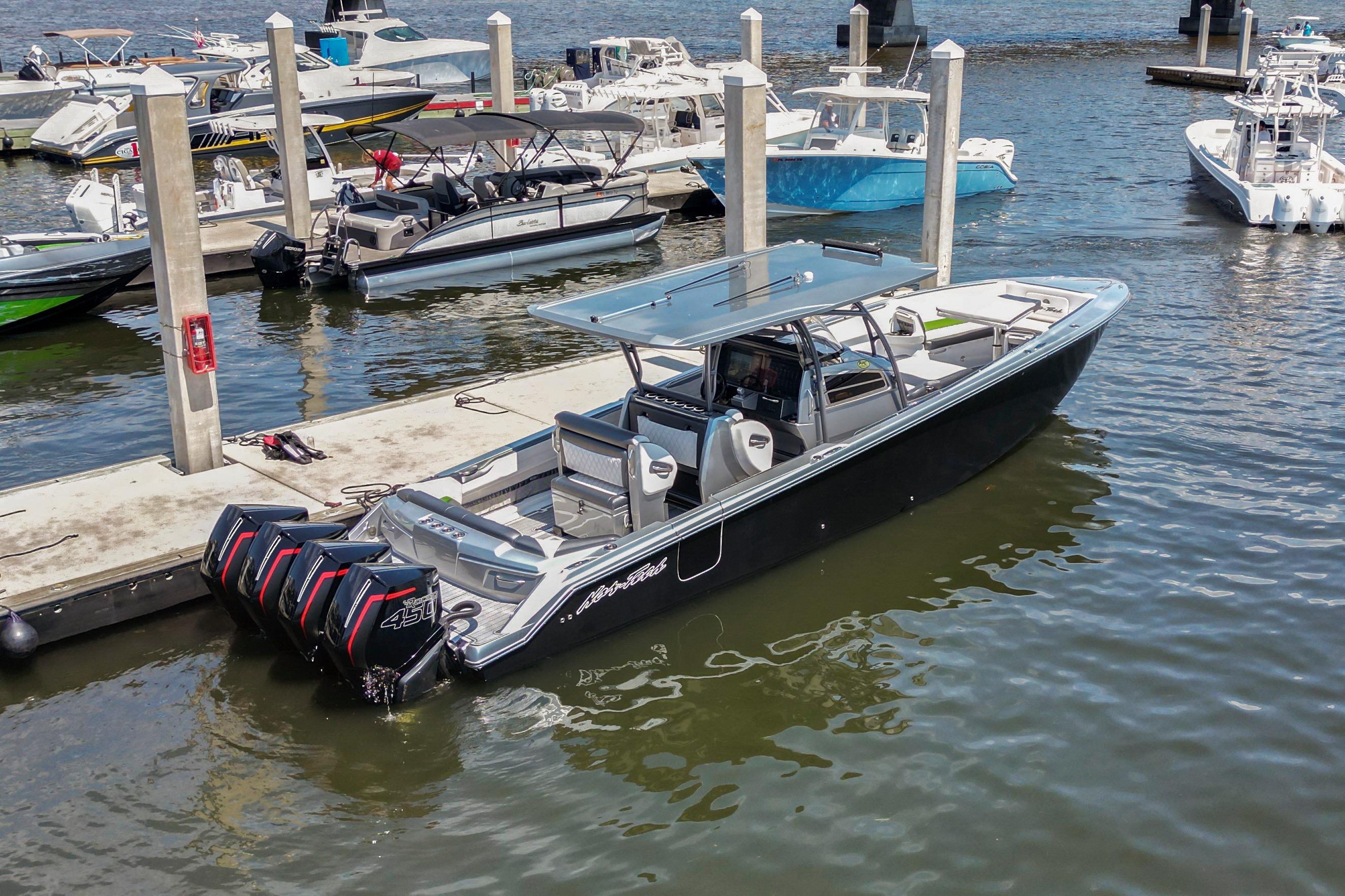 2021 Nor-Tech 390 Sport Center Console boat docked at marina with multiple engines.