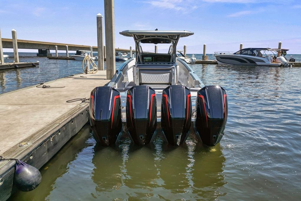 2021 Nor-Tech 390 Sport Center Console with quad engines docked at marina.
