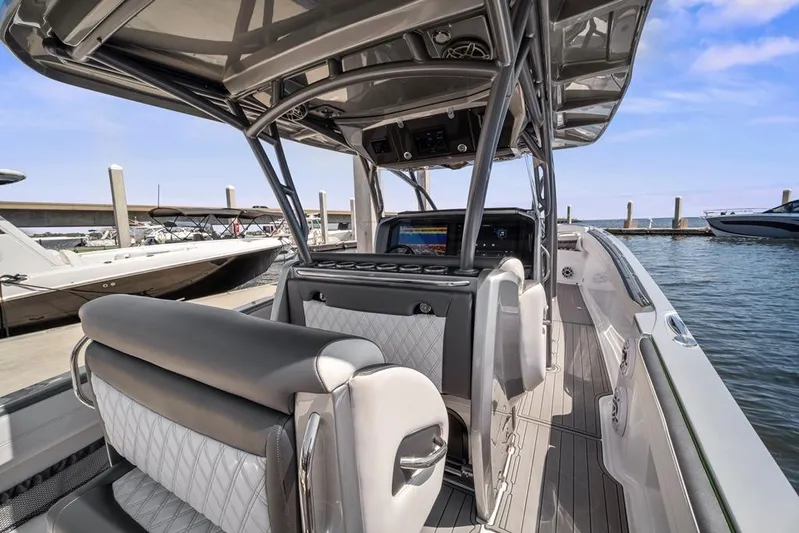  Yacht Photos Pics 2021 Nor-Tech 390 Sport Center Console boat interior at marina, showcasing helm and seating.