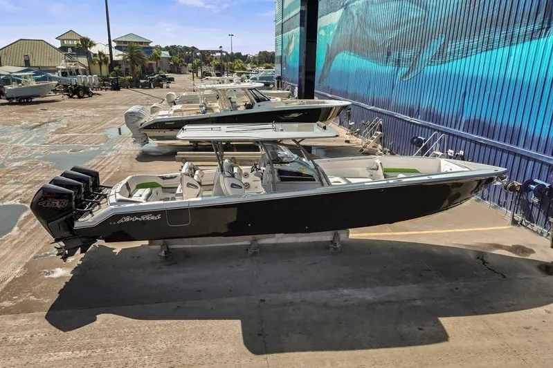  Yacht Photos Pics 2021 Nor-Tech 390 Sport Center Console boat with triple outboard engines in a marina setting.