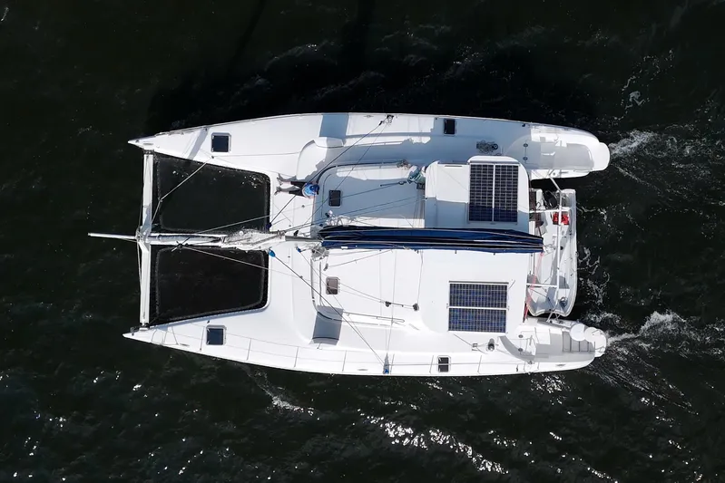 Route 66 Yacht Photos Pics Aerial view of 2005 Dolphin 460 Sail Catamaran with solar panels on open water.