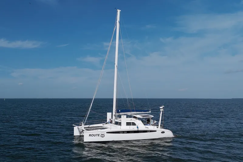 Route 66 Yacht Photos Pics 2005 Dolphin 460 Sail Catamaran on open sea under clear blue sky.