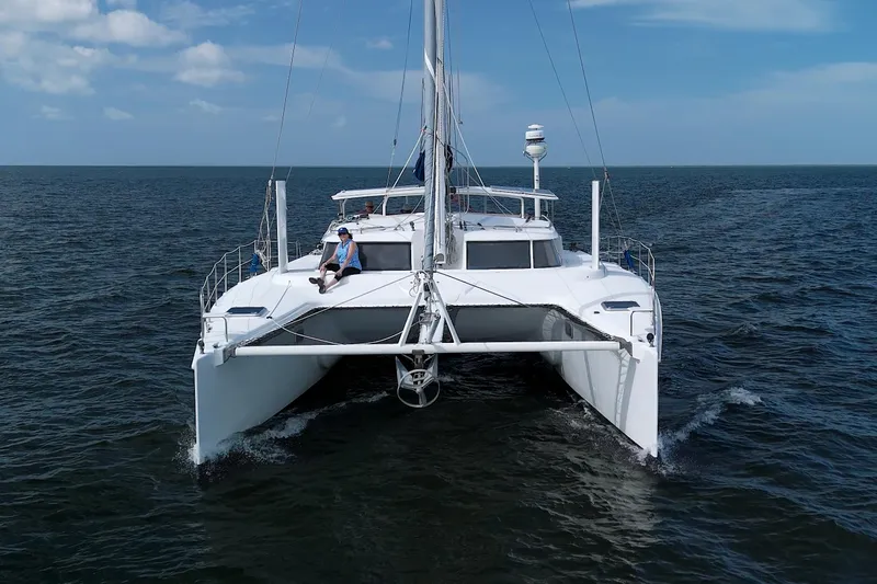 Route 66 Yacht Photos Pics 2005 Dolphin 460 Sail Catamaran cruising on open sea under clear blue sky.