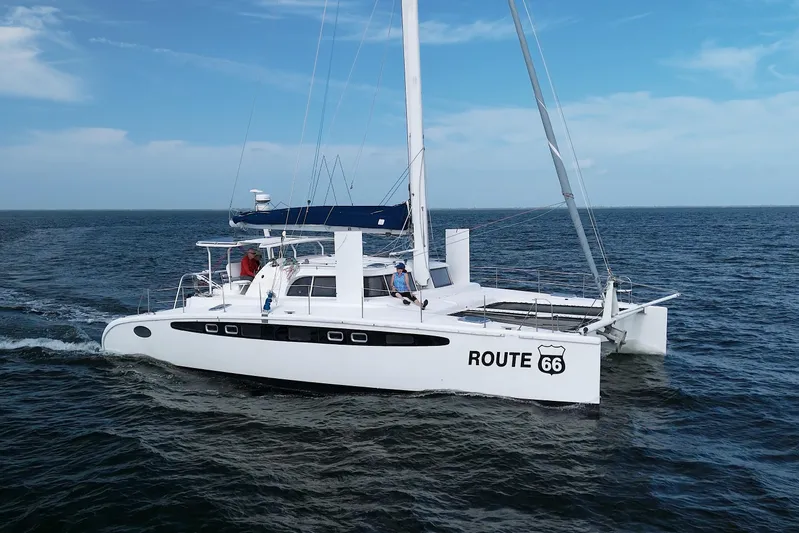 Route 66 Yacht Photos Pics 2005 Dolphin 460 Sail Catamaran cruising on open sea under clear skies.