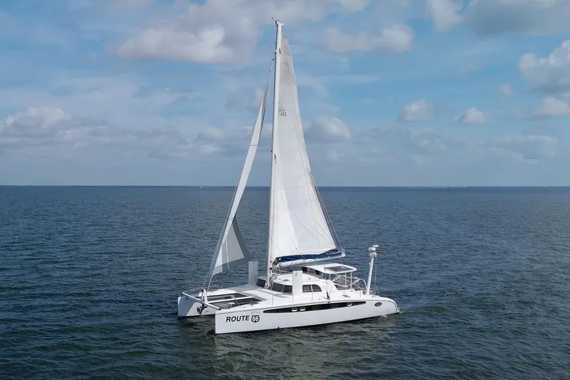 Route 66 Yacht Photos Pics 2005 Dolphin 460 Sail Catamaran sailing on open sea under clear skies.