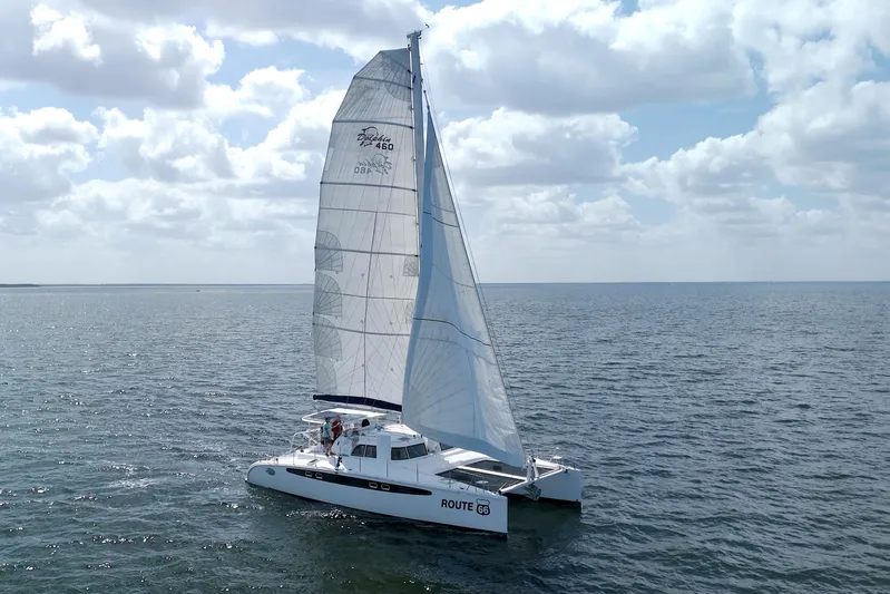 Route 66 Yacht Photos Pics Sailing catamaran Dolphin 460 Sail Cat 2005 on open sea under cloudy sky.