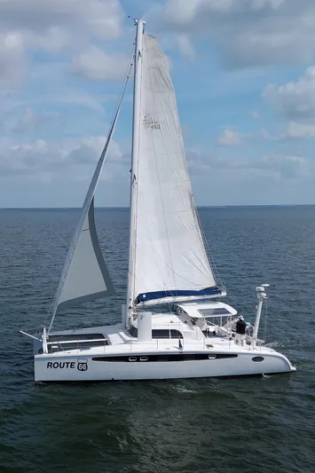 Route 66 Yacht Photos Pics 2005 Dolphin 460 Sail Catamaran sailing on open water under a partly cloudy sky.