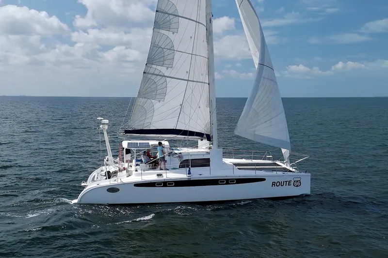 Route 66 Yacht Photos Pics Sailing catamaran Dolphin 460 Sail Cat 2005 on open sea with full sails.