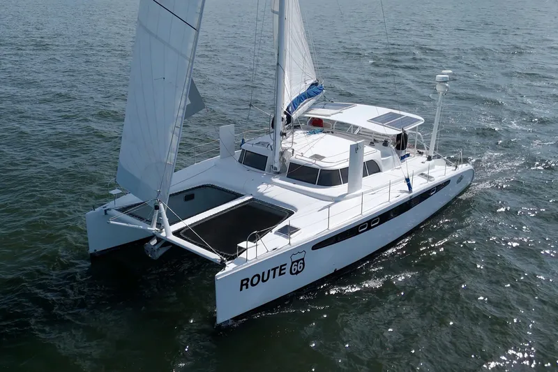 Route 66 Yacht Photos Pics 2005 Dolphin 460 Sail Catamaran sailing on open water, featuring sleek design and white sails.