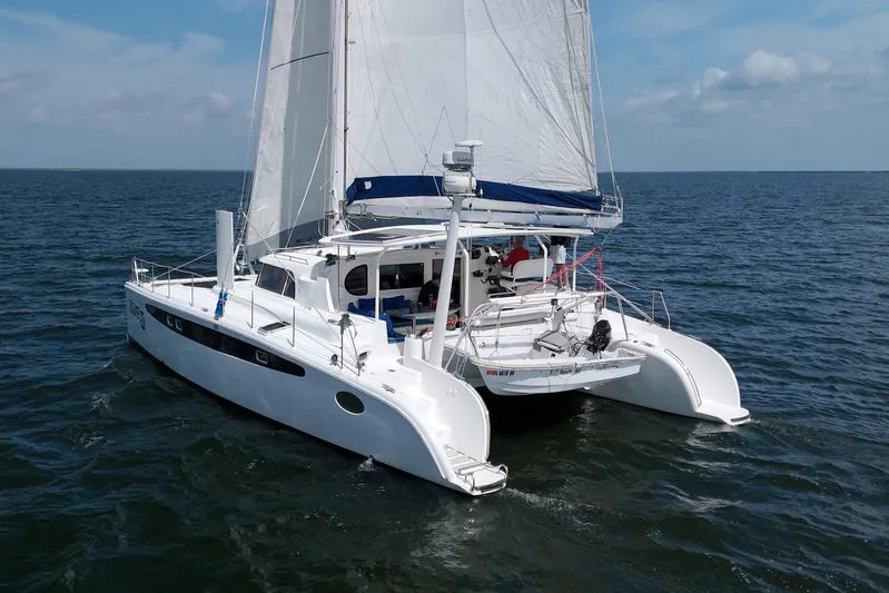 Route 66 Yacht Photos Pics 2005 Dolphin 460 Sail Catamaran cruising on open water under clear skies.