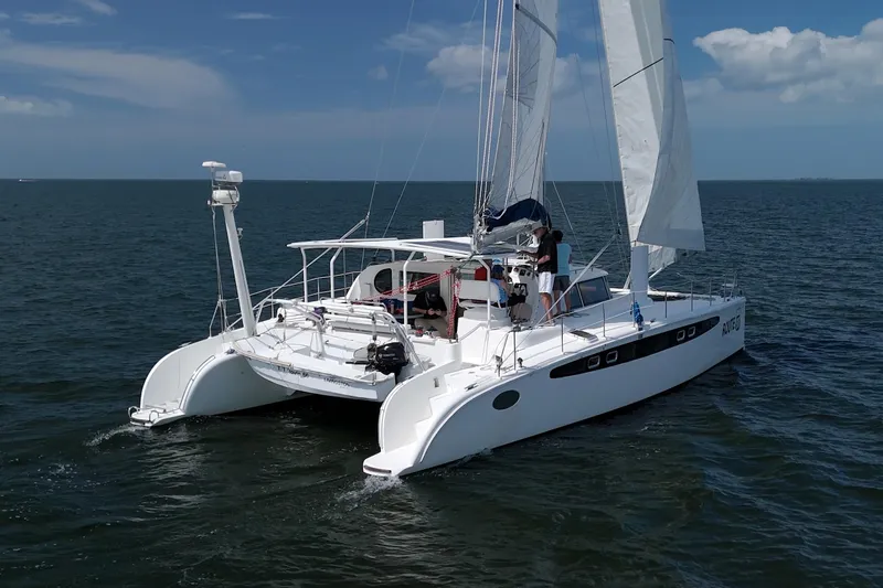 Route 66 Yacht Photos Pics 2005 Dolphin 460 Sail Catamaran cruising on open water under clear skies.