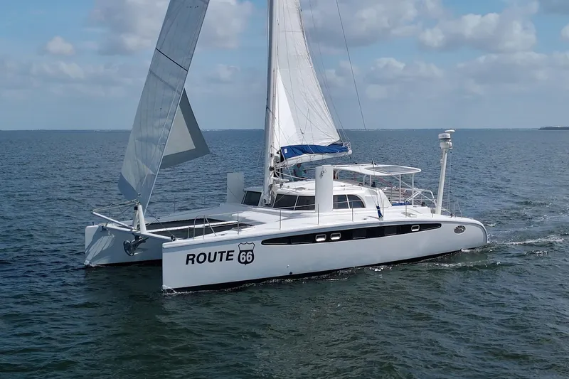 Route 66 Yacht Photos Pics 2005 Dolphin 460 Sail Catamaran sailing on open water under clear skies.