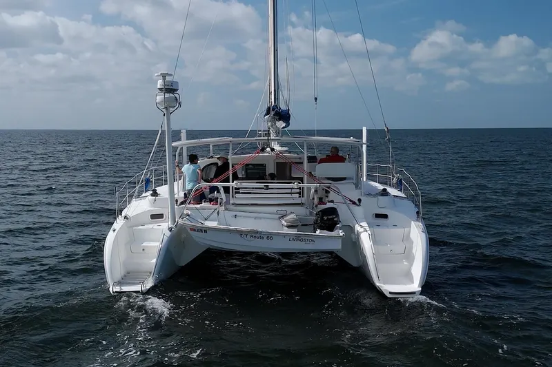 Route 66 Yacht Photos Pics 2005 Dolphin 460 Sail Catamaran sailing on open sea under blue sky.