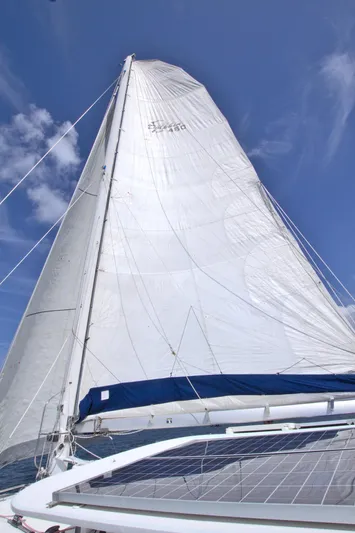 Route 66 Yacht Photos Pics Sail of 2005 Dolphin 460 Sail Cat against a clear blue sky.