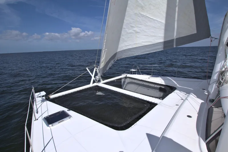 Route 66 Yacht Photos Pics Sailing on a 2005 Dolphin 460 Sail Catamaran in open sea under clear skies.