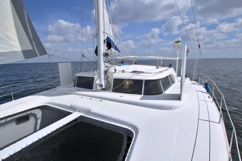 Route 66 Yacht Photos Pics 2005 Dolphin 460 Sail Catamaran on open sea under a partly cloudy sky.