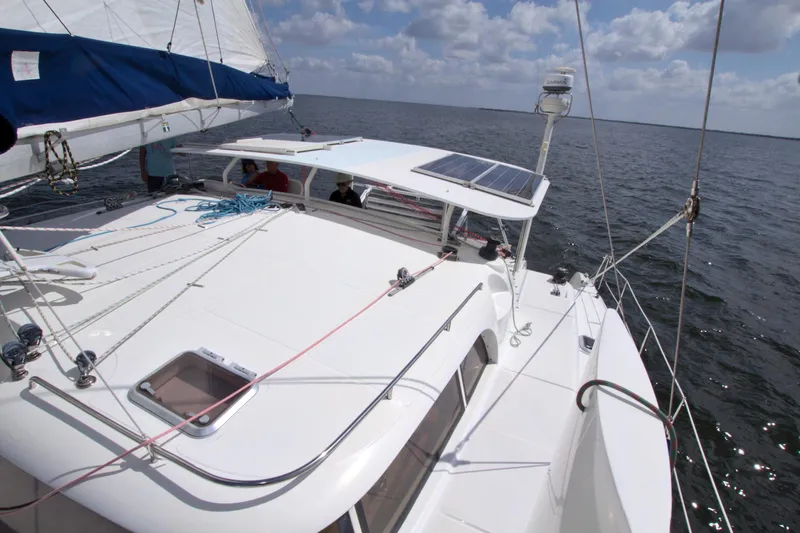 Route 66 Yacht Photos Pics 2005 Dolphin 460 Sail Catamaran on open water, featuring solar panels and sleek design.