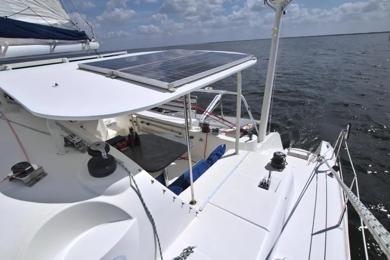 Route 66 Yacht Photos Pics Sailing catamaran Dolphin 460 with solar panels on deck, cruising on open water.