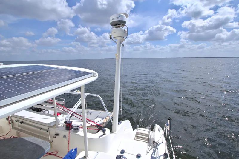 Route 66 Yacht Photos Pics 2005 Dolphin 460 Sail Cat on open water, featuring solar panels and navigational equipment.