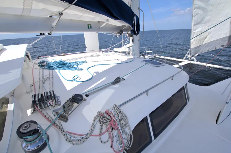 Route 66 Yacht Photos Pics 2005 Dolphin 460 Sail Catamaran deck with ropes and winches, sailing on open sea.