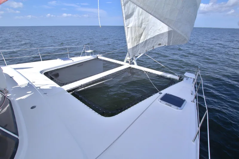 Route 66 Yacht Photos Pics 2005 Dolphin 460 Sail Catamaran on open sea with sails unfurled.