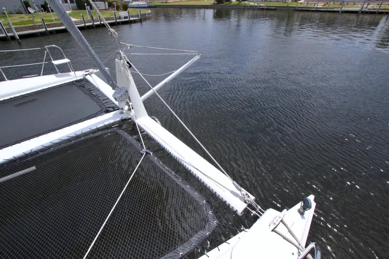 Route 66 Yacht Photos Pics 2005 Dolphin 460 Sail Catamaran on calm water, showcasing deck and netting.