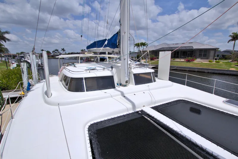 Route 66 Yacht Photos Pics 2005 Dolphin 460 Sail Catamaran docked, showcasing spacious deck and sleek design.