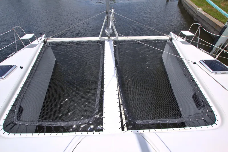 Route 66 Yacht Photos Pics 2005 Dolphin 460 Sail Catamaran with dual trampolines over water.