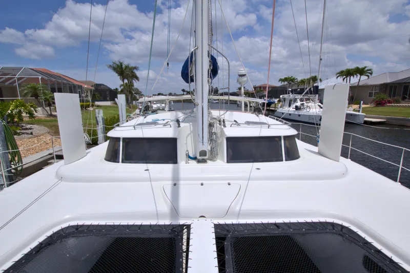 Route 66 Yacht Photos Pics 2005 Dolphin 460 Sail Catamaran docked under a partly cloudy sky.