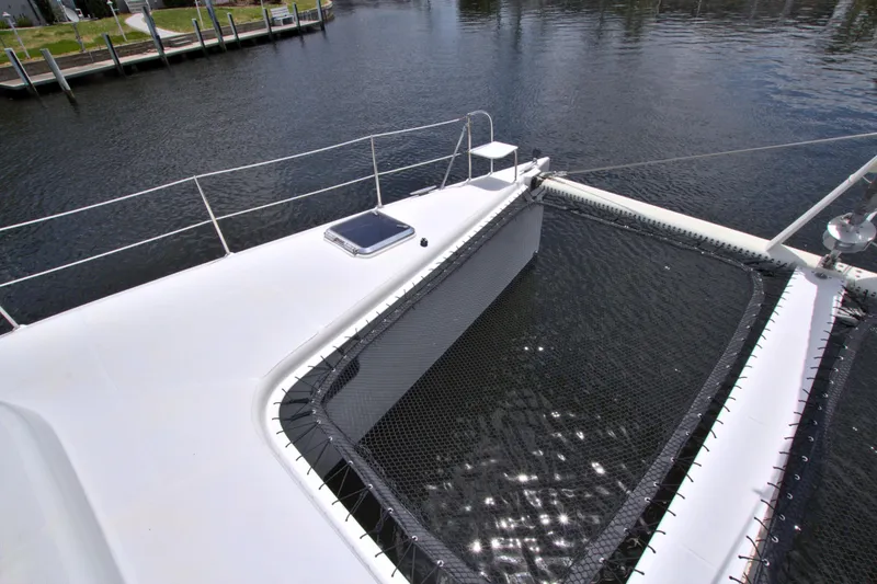 Route 66 Yacht Photos Pics 2005 Dolphin 460 Sail Catamaran deck with netting over water.