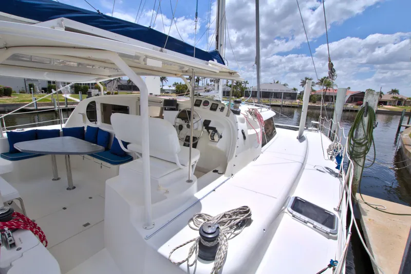 Route 66 Yacht Photos Pics 2005 Dolphin 460 Sail Catamaran docked, featuring spacious deck and seating area under clear skies.