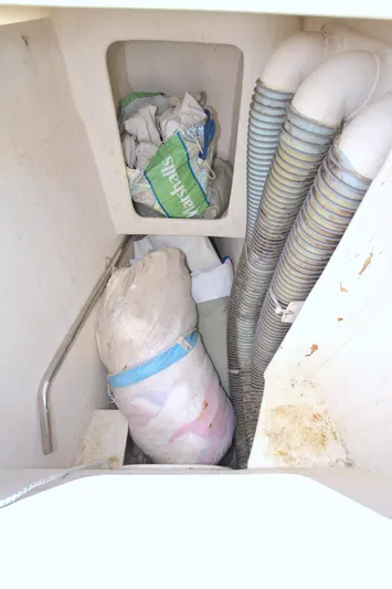 Route 66 Yacht Photos Pics Storage compartment on a 2005 Dolphin 460 Sail Cat with bags and ventilation hoses.