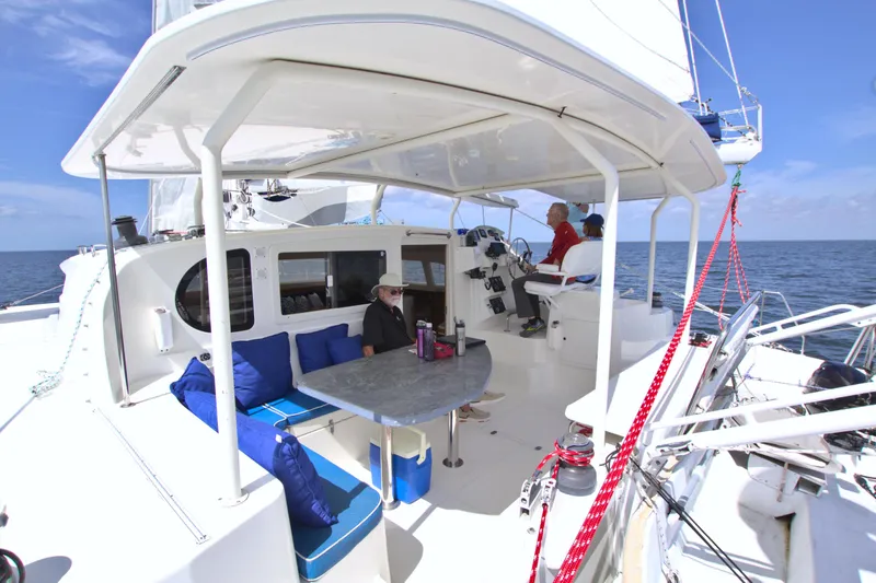 Route 66 Yacht Photos Pics 2005 Dolphin 460 Sail Catamaran with spacious deck, seating area, and ocean view.