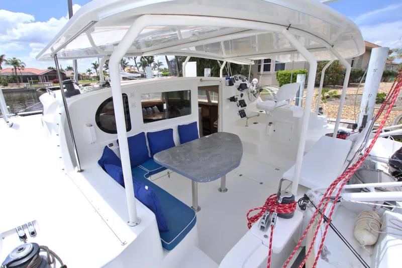 Route 66 Yacht Photos Pics 2005 Dolphin 460 Sail Catamaran with outdoor seating and helm station, docked in a marina.