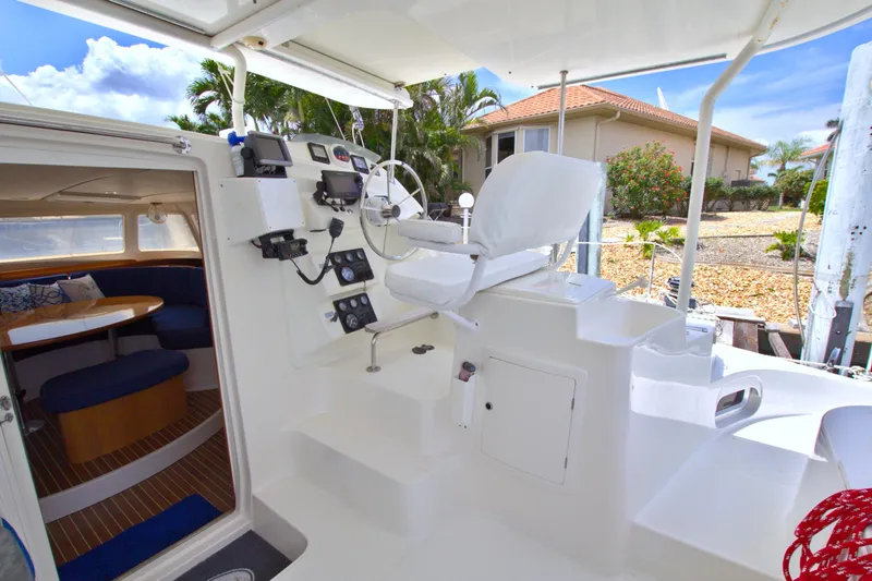 Route 66 Yacht Photos Pics 2005 Dolphin 460 Sail Cat cockpit with steering, controls, and cabin view.