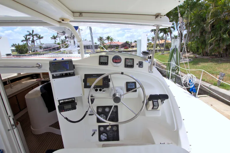 Route 66 Yacht Photos Pics Helm of 2005 Dolphin 460 Sail Catamaran with navigation instruments and steering wheel.