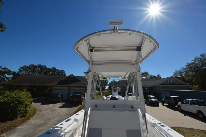 Hot Hooks Yacht Photos Pics 2006 Contender 33 Tournament boat under bright sun, parked in residential driveway.