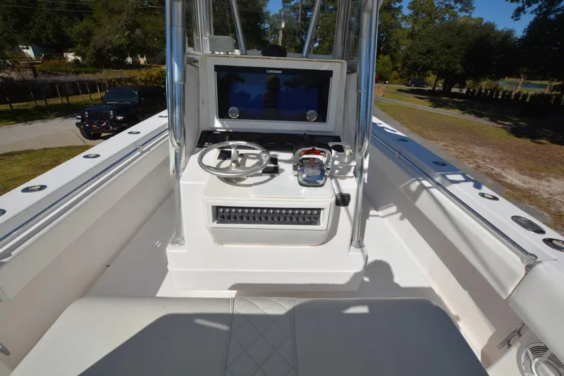 Hot Hooks Yacht Photos Pics 2006 Contender 33 Tournament boat helm with steering wheel and navigation display.
