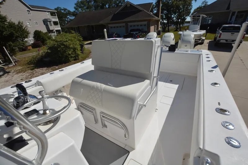 Hot Hooks Yacht Photos Pics 2006 Contender 33 Tournament boat interior with steering wheel and seating.