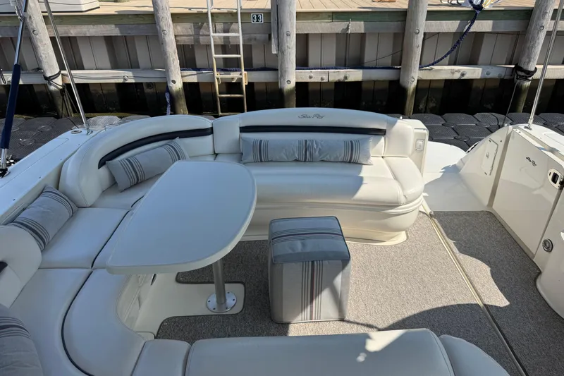 Grand Bleu Yacht Photos Pics 2003 Sea Ray 420 Sundancer yacht with elegant white seating and table in the cockpit area.