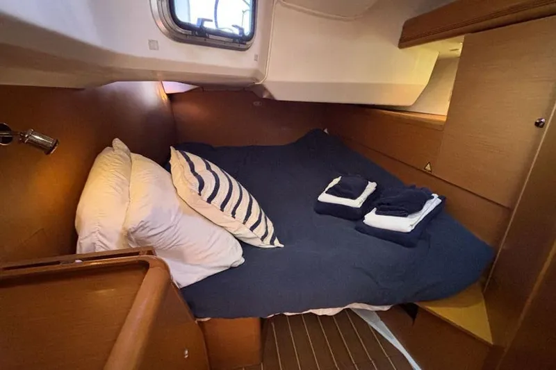 Hanalei Yacht Photos Pics Cozy cabin interior of 2011 Jeanneau Sun Odyssey 44 sailboat with neatly arranged bedding.