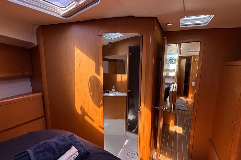 Hanalei Yacht Photos Pics Interior of 2011 Jeanneau Sun Odyssey 44 yacht, featuring wood paneling and a compact bathroom.