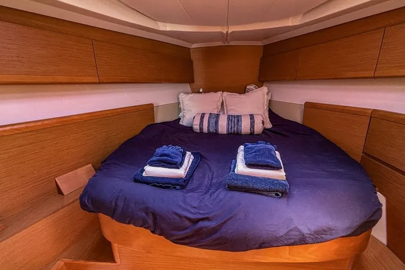Hanalei Yacht Photos Pics Cozy cabin interior of 2011 Jeanneau Sun Odyssey 44 with neatly arranged bedding.