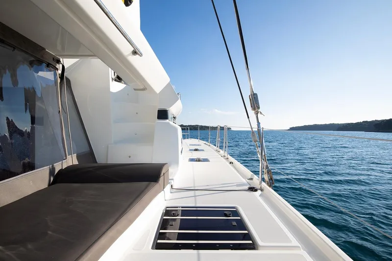Aliana Yacht Photos Pics 2022 Lagoon 50 catamaran deck with ocean view and clear blue sky.