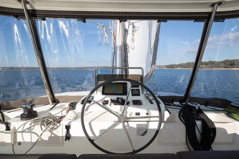 Aliana Yacht Photos Pics Cockpit view of 2022 Lagoon 50 catamaran sailing on open water.