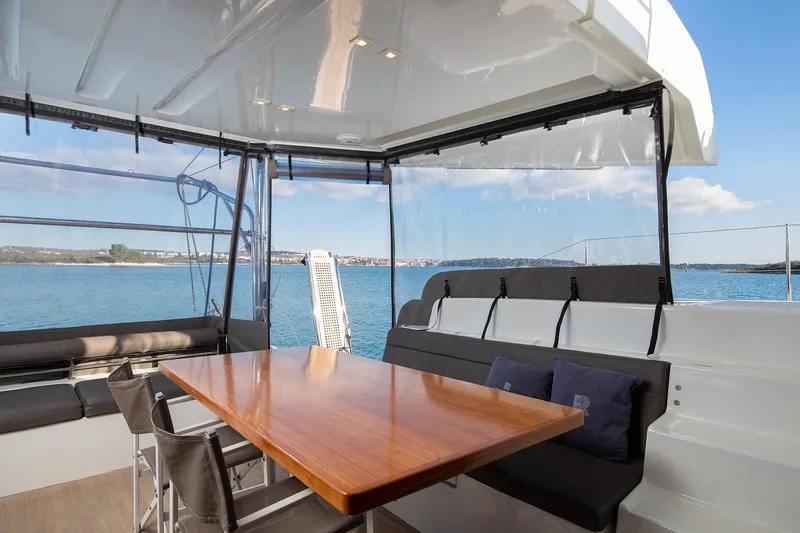 Aliana Yacht Photos Pics Spacious deck area of 2022 Lagoon 50 catamaran with seating and ocean view.