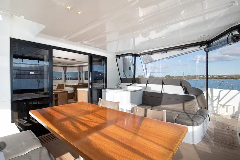 Aliana Yacht Photos Pics Luxurious Lagoon 50 catamaran interior, featuring elegant seating and dining area, 2022 model.