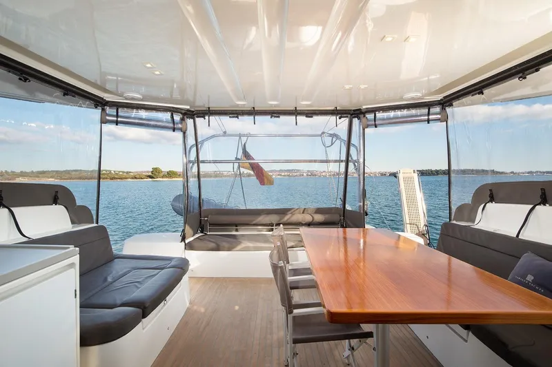 Aliana Yacht Photos Pics Spacious interior of 2022 Lagoon 50 yacht with ocean view and elegant seating area.